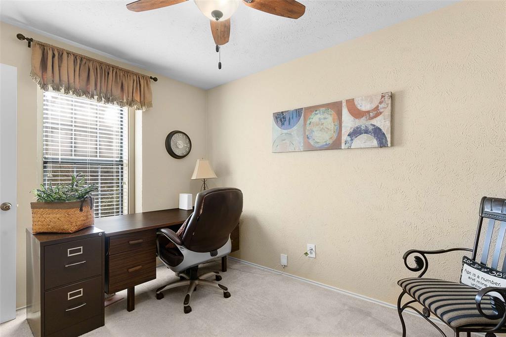 14683 Plage Lane Addison, TX 75001 - Photo 18 of 39 Office area featuring light colored carpet, a ceiling fan, and a textured wall