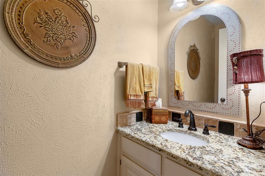 14683 Plage Lane Addison, TX 75001 - Photo 20 of 39 Bathroom featuring a textured wall and vanity