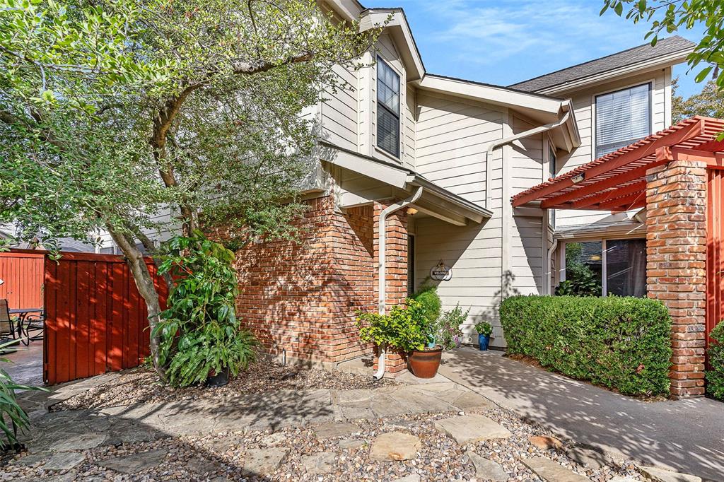 14683 Plage Lane Addison, TX 75001 - Photo 22 of 39 View of front facade with brick siding and a pergola