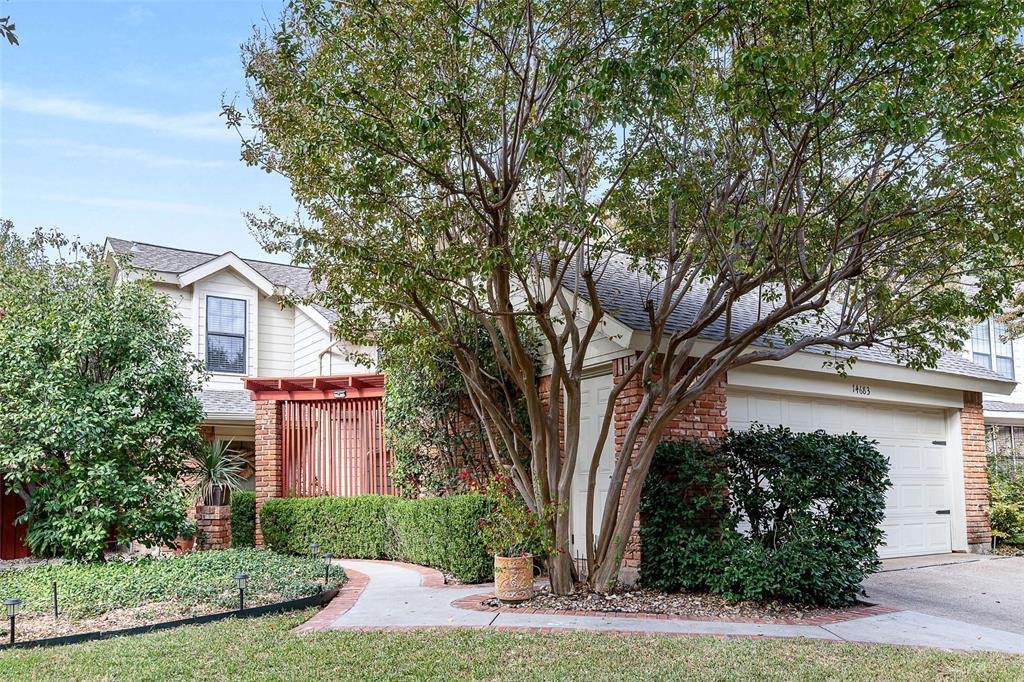 14683 Plage Lane Addison, TX 75001 - Photo 23 of 39 View of front facade featuring brick siding, a garage, roof with shingles, and driveway