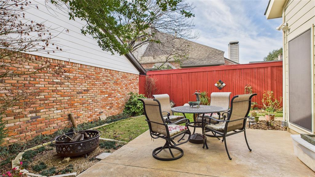 14683 Plage Lane Addison, TX 75001 - Photo 27 of 39 Fenced backyard featuring a patio area, outdoor dining space, and an outdoor fire pit