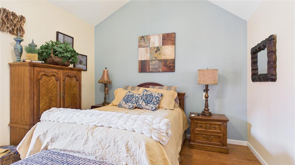 14683 Plage Lane Addison, TX 75001 - Photo 10 of 39 Bedroom with vaulted ceiling and wood finished floors