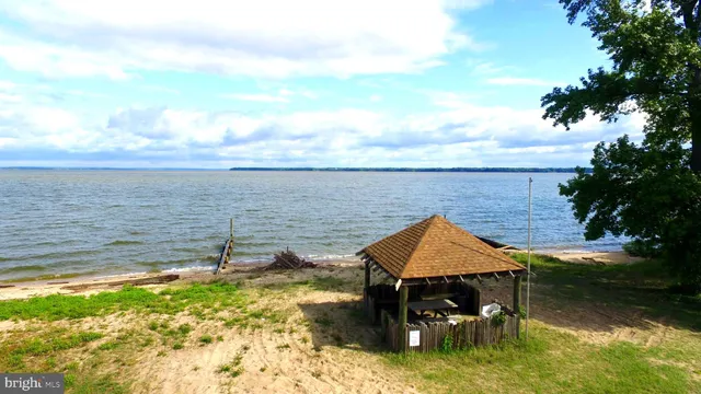 a view of a lake with lawn chairs and iron floor