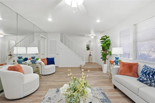 a living room with furniture and a chandelier