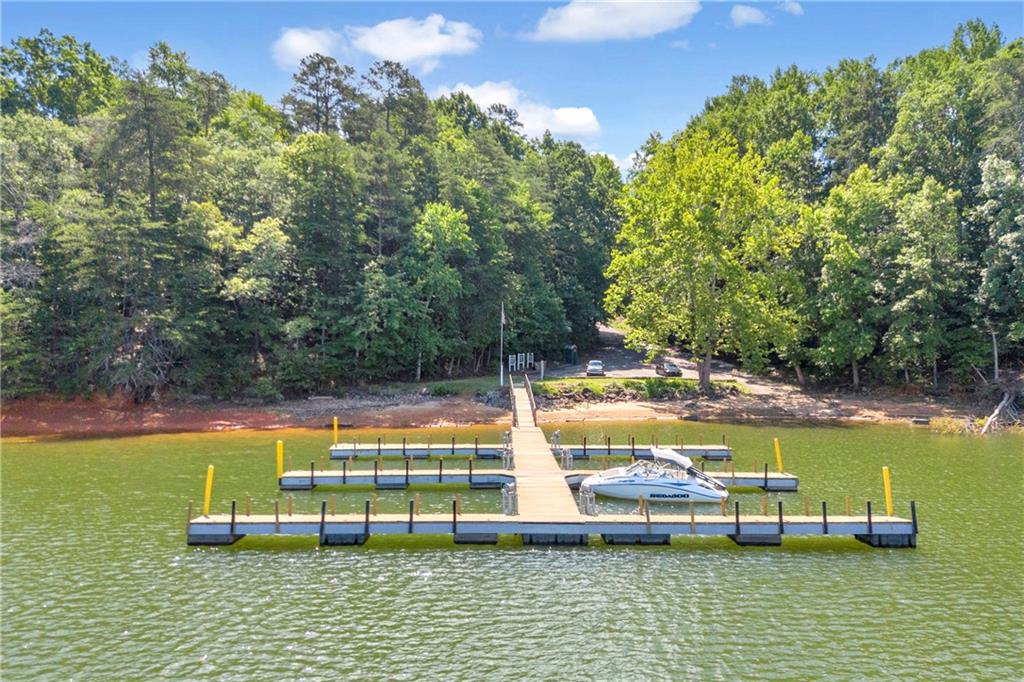 2941 Lake Hollow Road Gainesville, GA 30501 - Photo 41 of 53 a view of a swimming pool with lawn chairs under an umbrella