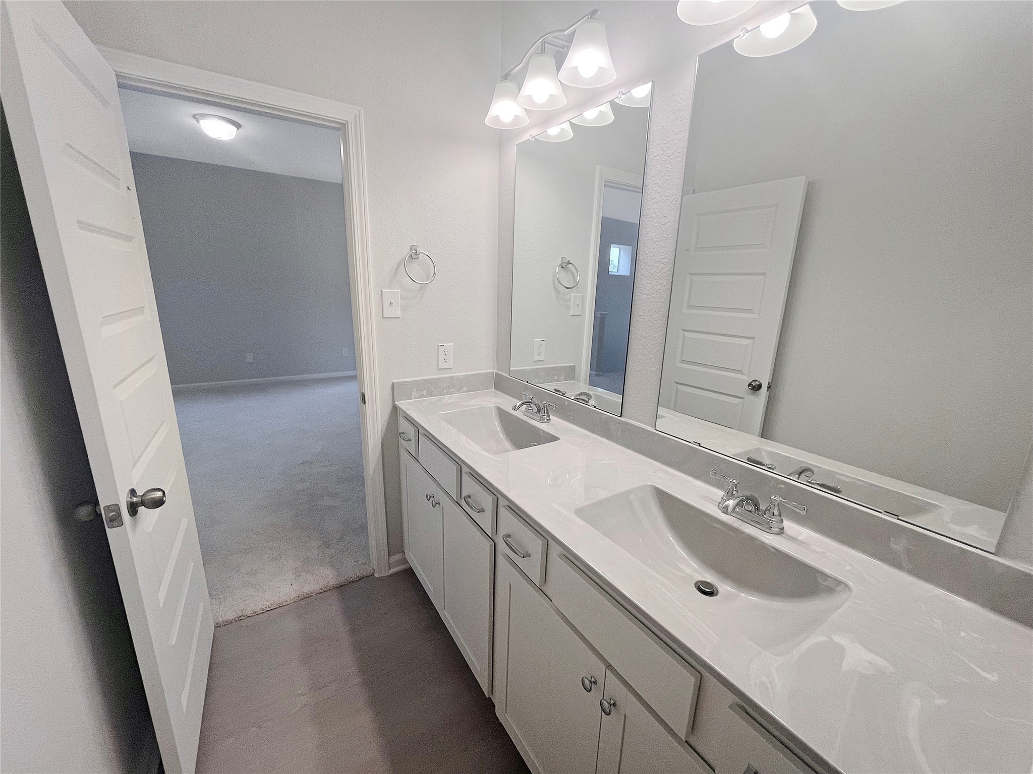 9765 Enclave Ridge Road Willis, TX 77318 - Photo 13 of 18 a bathroom with a double vanity sink and a mirror