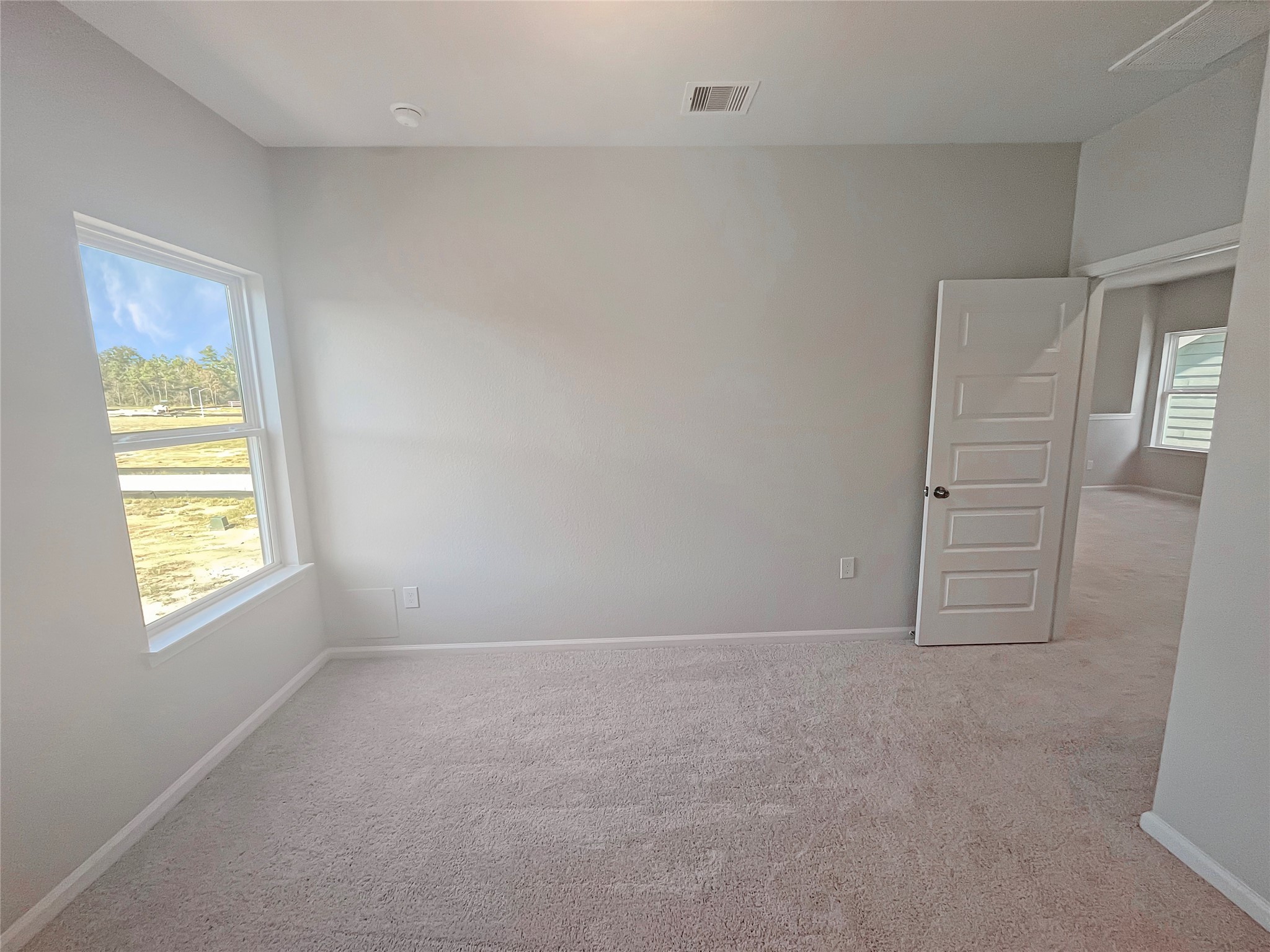 9765 Enclave Ridge Road Willis, TX 77318 - Photo 14 of 18 an empty room with windows and closet