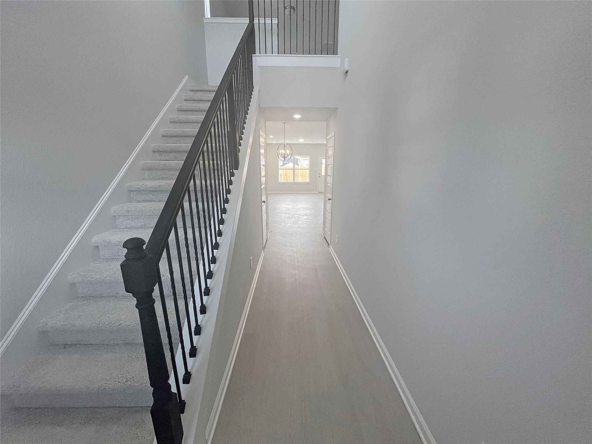 9765 Enclave Ridge Road Willis, TX 77318 - Photo 2 of 18 a view of a hallway with wooden floor and stairs