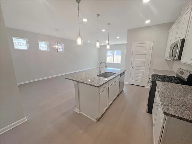 a kitchen with a sink stove and refrigerator