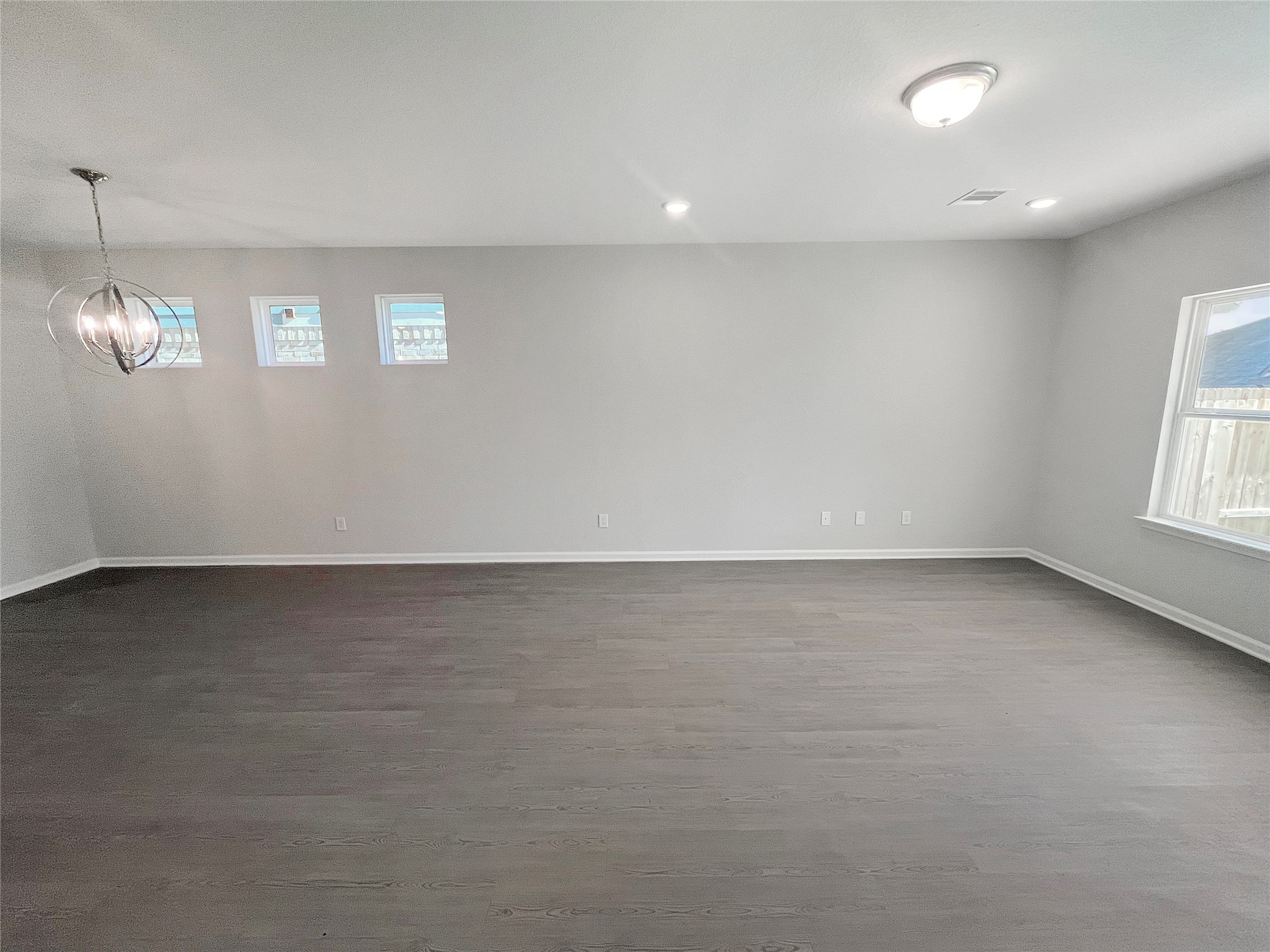 9765 Enclave Ridge Road Willis, TX 77318 - Photo 7 of 18 an empty room with stairs and windows