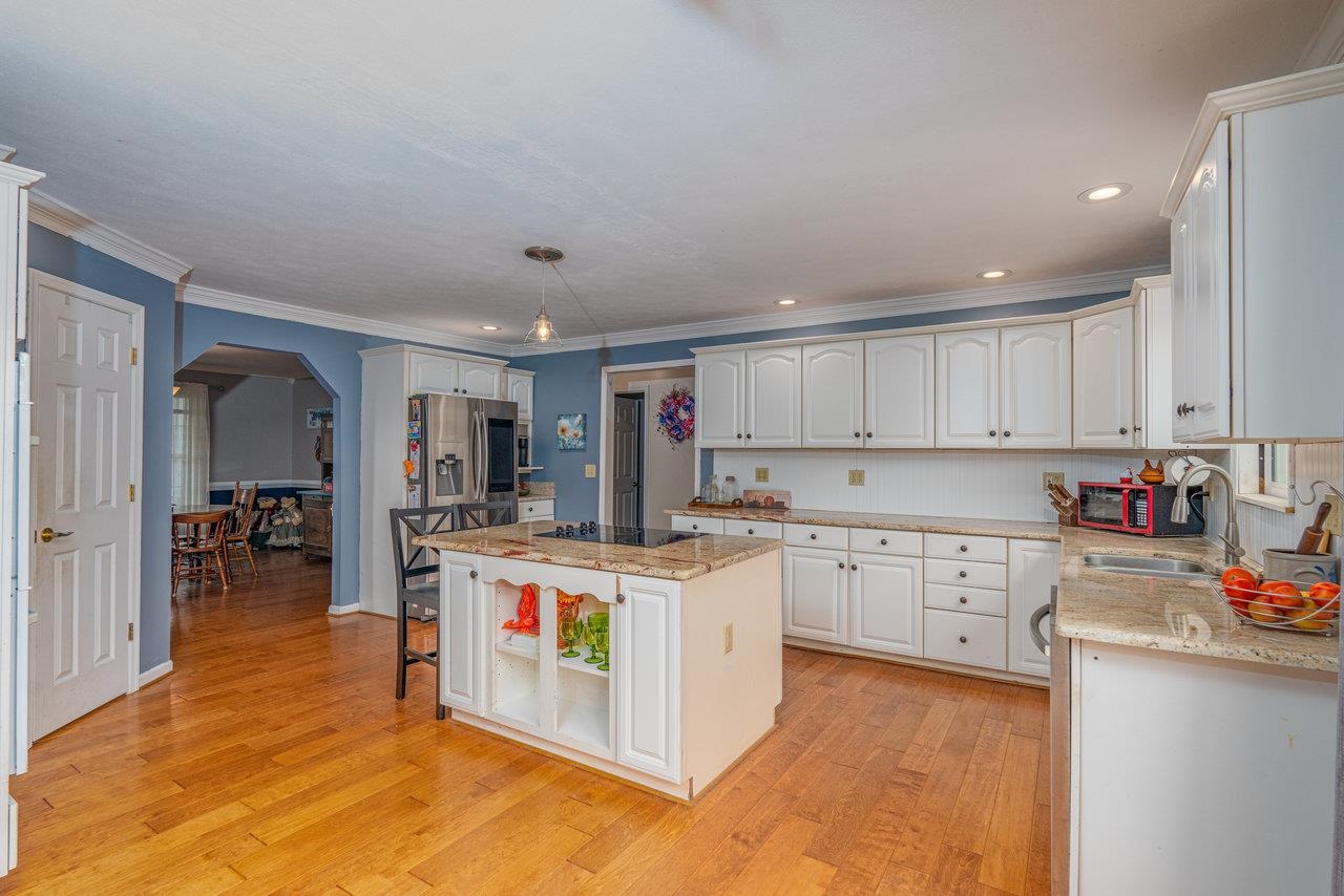 328 Morton Road Crimora, VA 24431 - Photo 11 of 32 a kitchen with cabinets and wooden floor