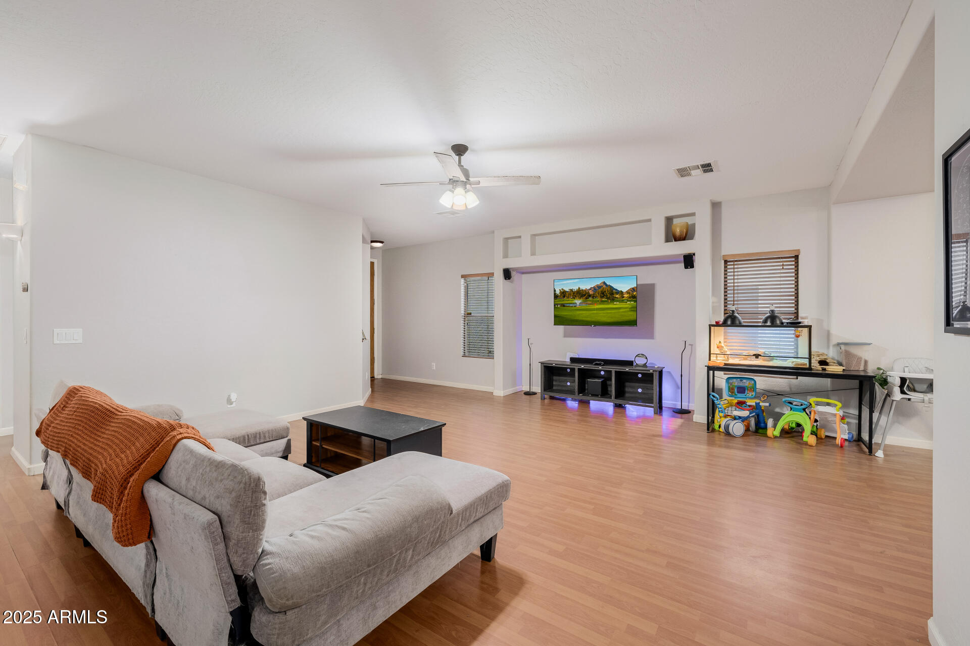 241 Mountain View Road San Tan Valley, AZ 85143 - Photo 20 of 62 a living room with furniture and a dining table with wooden floor