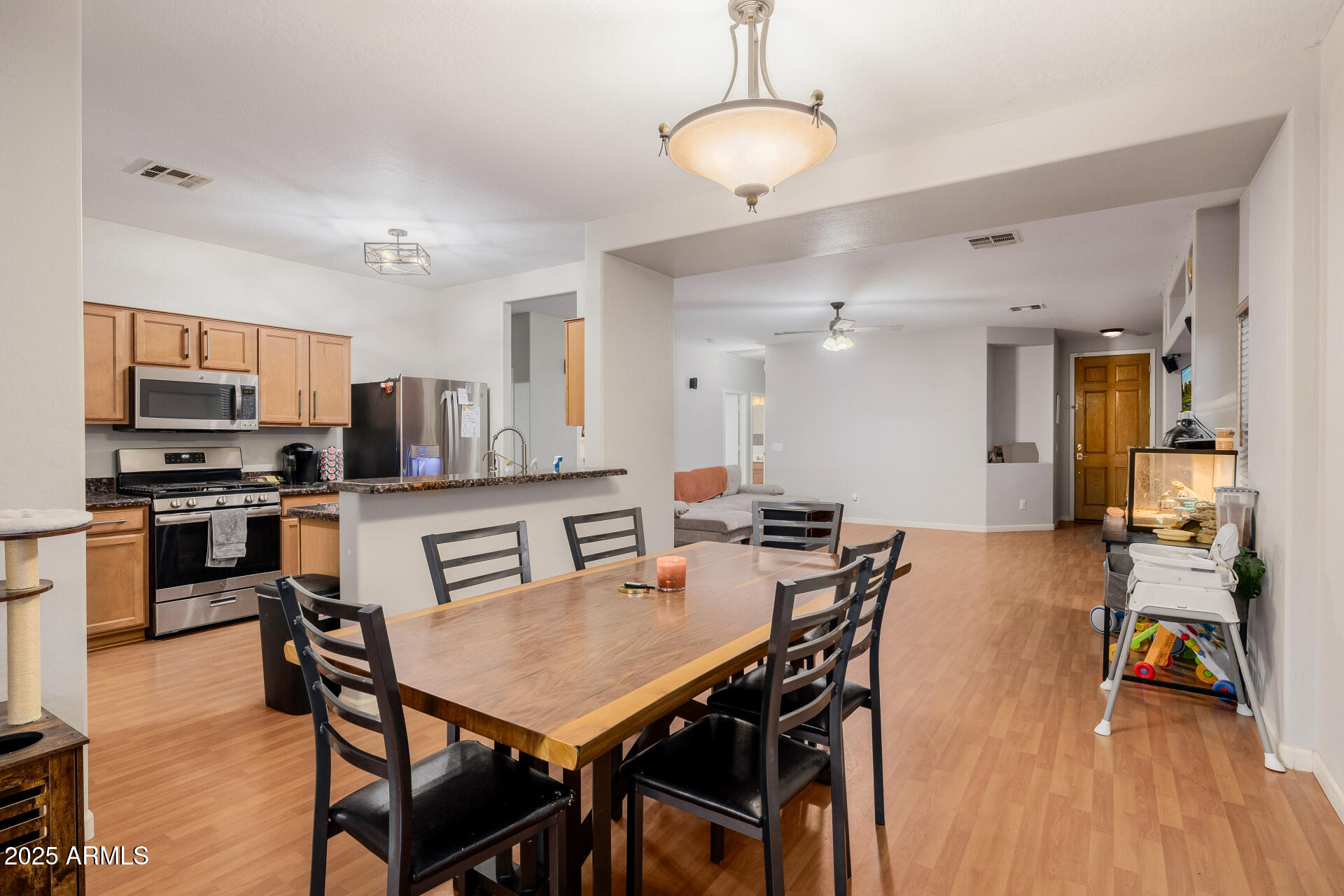 241 Mountain View Road San Tan Valley, AZ 85143 - Photo 23 of 62 a view of a dining room and livingroom with furniture wooden floor a chandelier