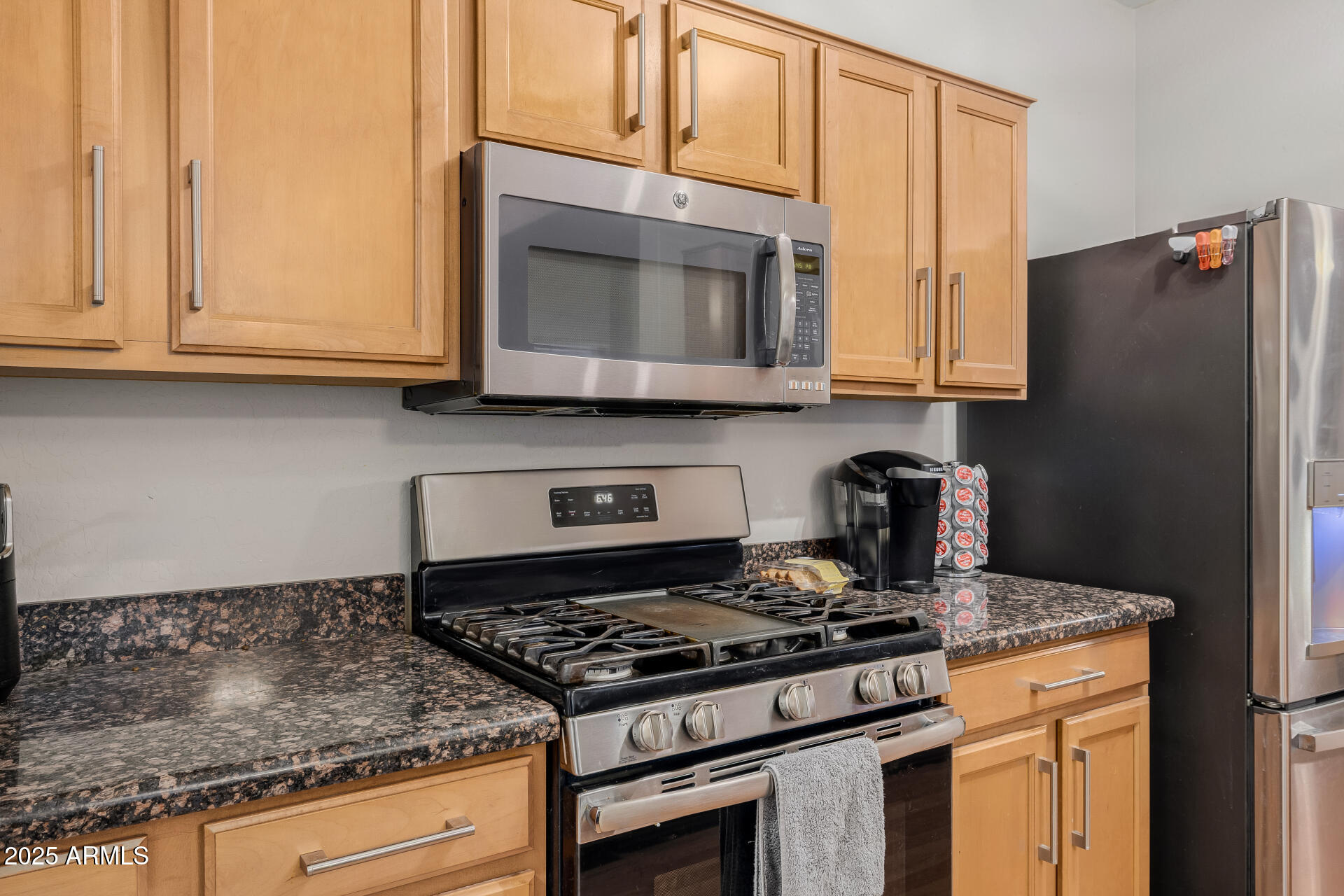 241 Mountain View Road San Tan Valley, AZ 85143 - Photo 30 of 62 a kitchen with stainless steel appliances granite countertop a stove a microwave and a sink