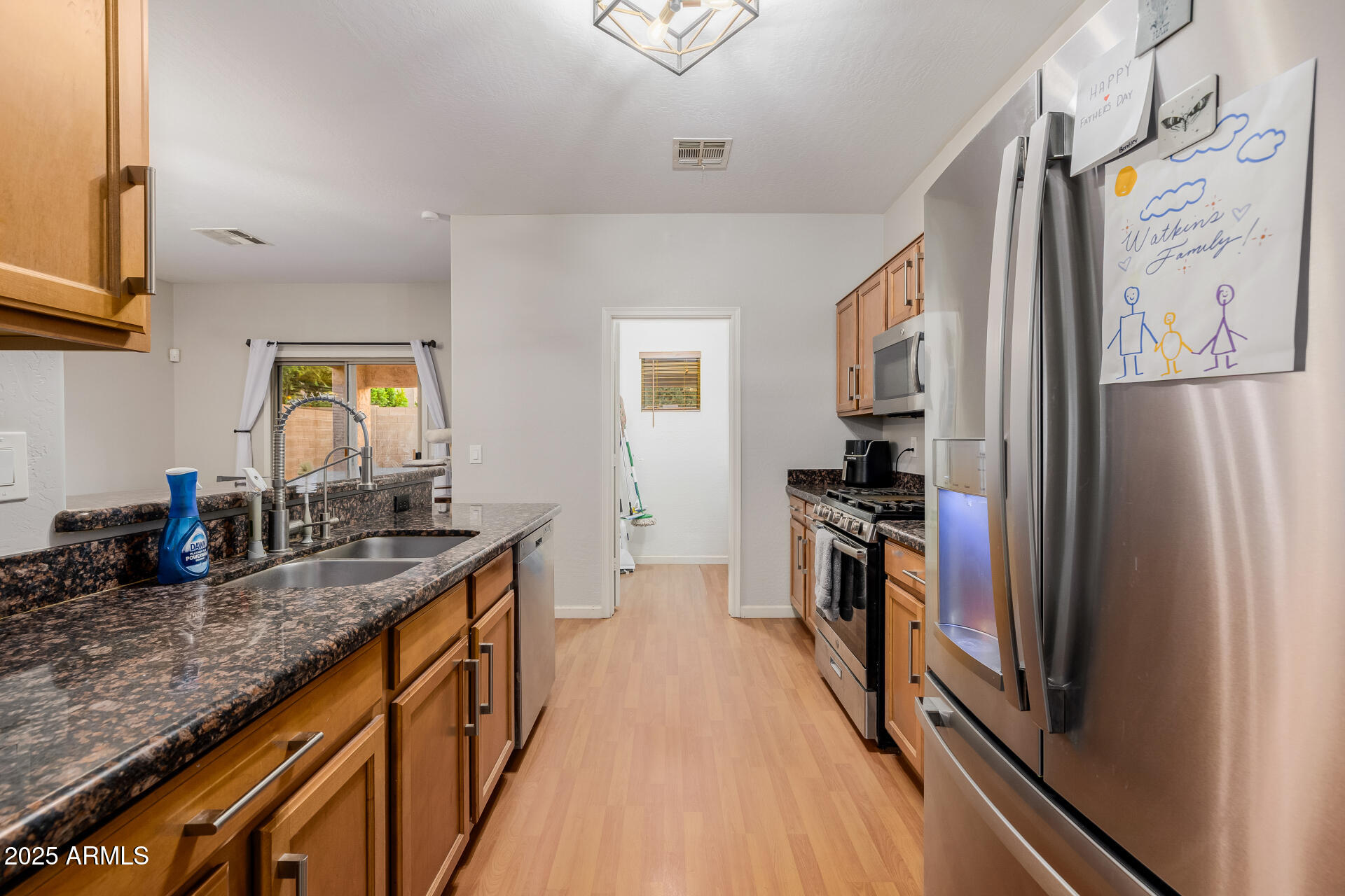 241 Mountain View Road San Tan Valley, AZ 85143 - Photo 32 of 62 a kitchen with stainless steel appliances granite countertop a refrigerator and a stove