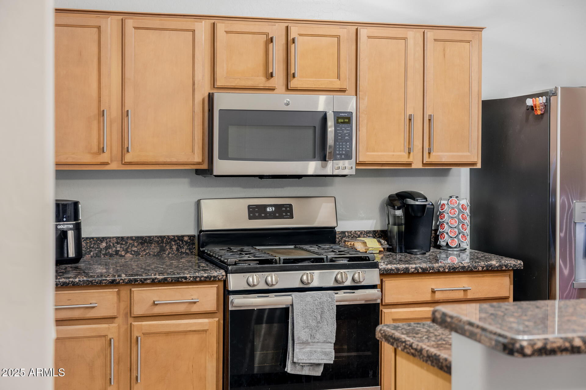 241 Mountain View Road San Tan Valley, AZ 85143 - Photo 33 of 62 a kitchen with stainless steel appliances granite countertop a stove a microwave and refrigerator