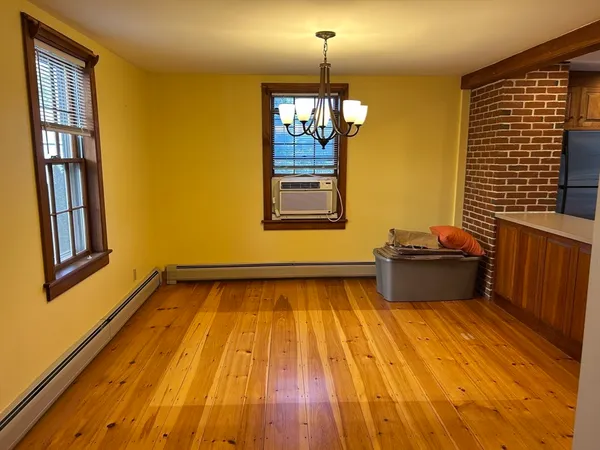a view of a livingroom with wooden floor and staircase