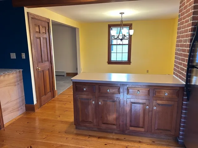 a view of kitchen with granite countertop cabinets and wooden floor