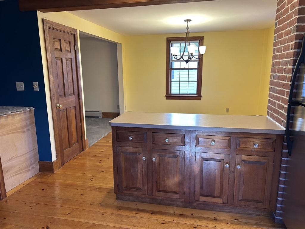 33 Woodland Street, Unit 1 Newburyport, MA 01950 - Photo 5 of 11 a view of kitchen with granite countertop cabinets and wooden floor
