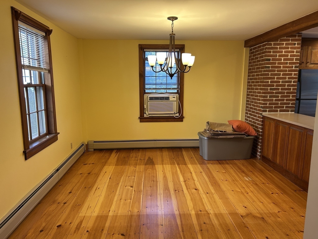 33 Woodland Street, Unit 1 Newburyport, MA 01950 - Photo 6 of 11 a view of a livingroom with wooden floor and staircase