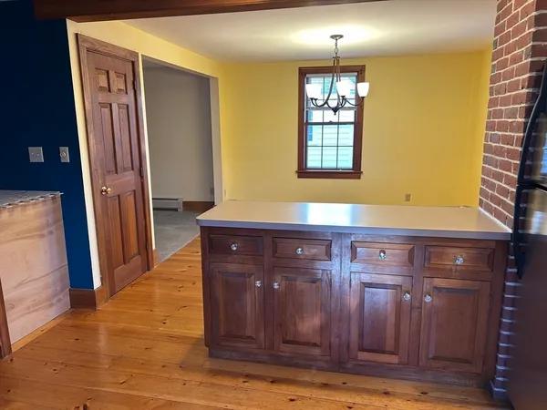a view of kitchen with granite countertop cabinets and wooden floor