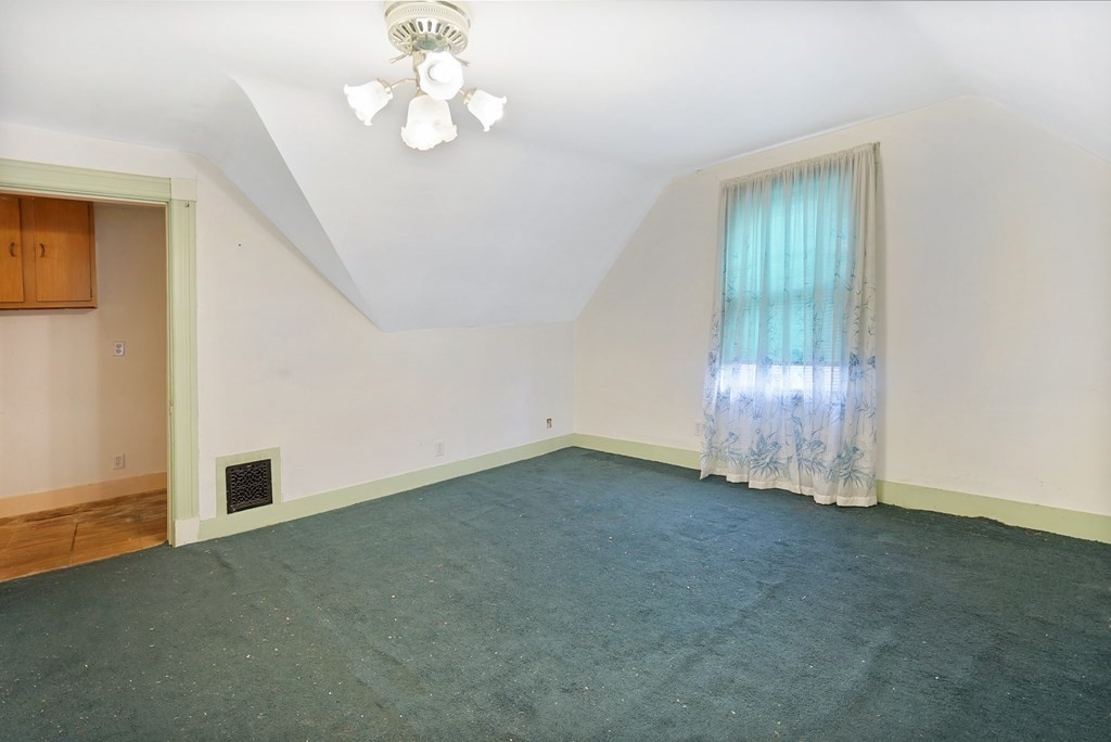 237-239 White Street Springfield, MA 01108 - Photo 20 of 31 an empty room with chandelier fan and windows