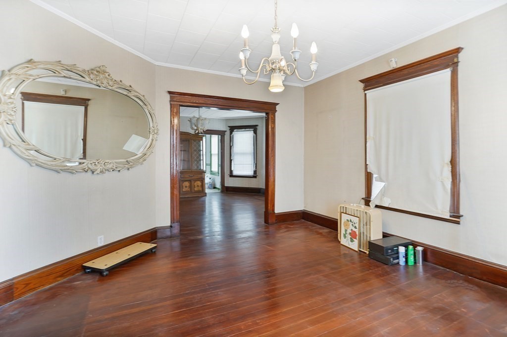 237-239 White Street Springfield, MA 01108 - Photo 2 of 31 a view of a hallway with wooden floor and a chandelier