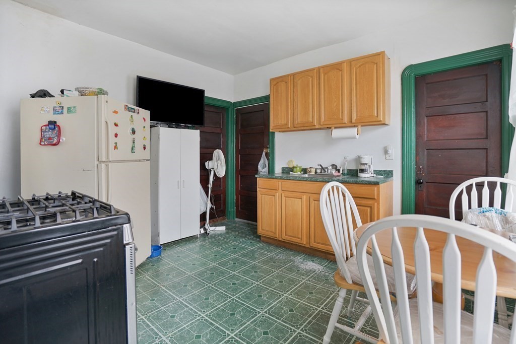 237-239 White Street Springfield, MA 01108 - Photo 26 of 31 a kitchen with stainless steel appliances granite countertop a stove a refrigerator and a stove