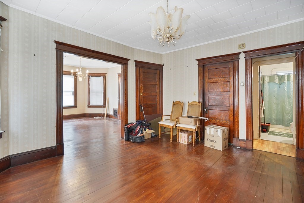 237-239 White Street Springfield, MA 01108 - Photo 5 of 31 a view of a livingroom with furniture and a table wooden floor