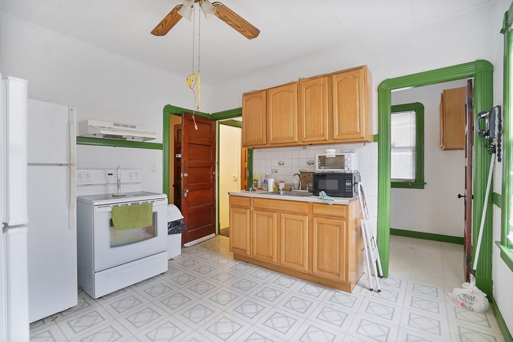 237-239 White Street Springfield, MA 01108 - Photo 6 of 31 a kitchen with a refrigerator sink and cabinets