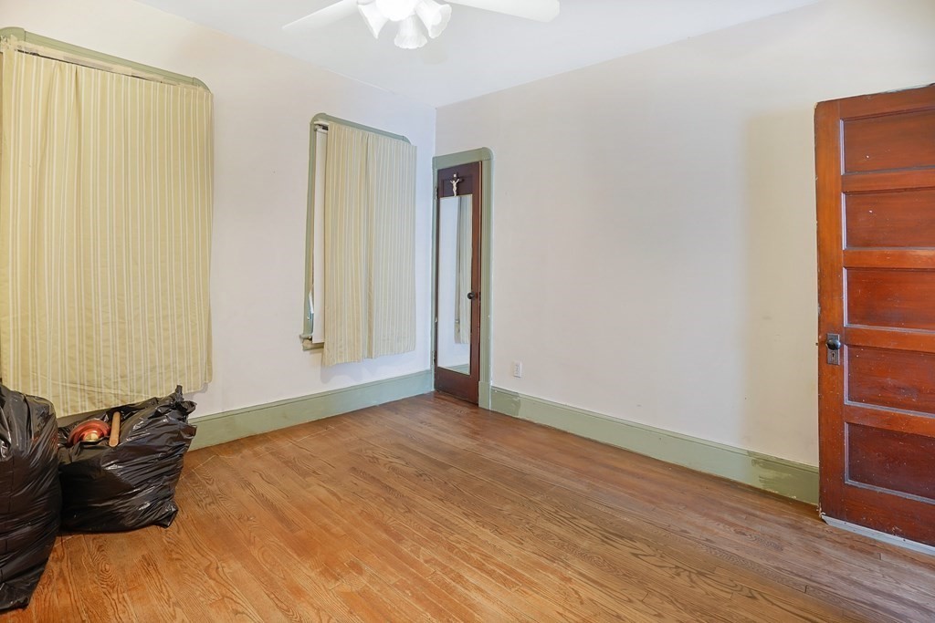 237-239 White Street Springfield, MA 01108 - Photo 9 of 31 an empty room with wooden floor closet and windows