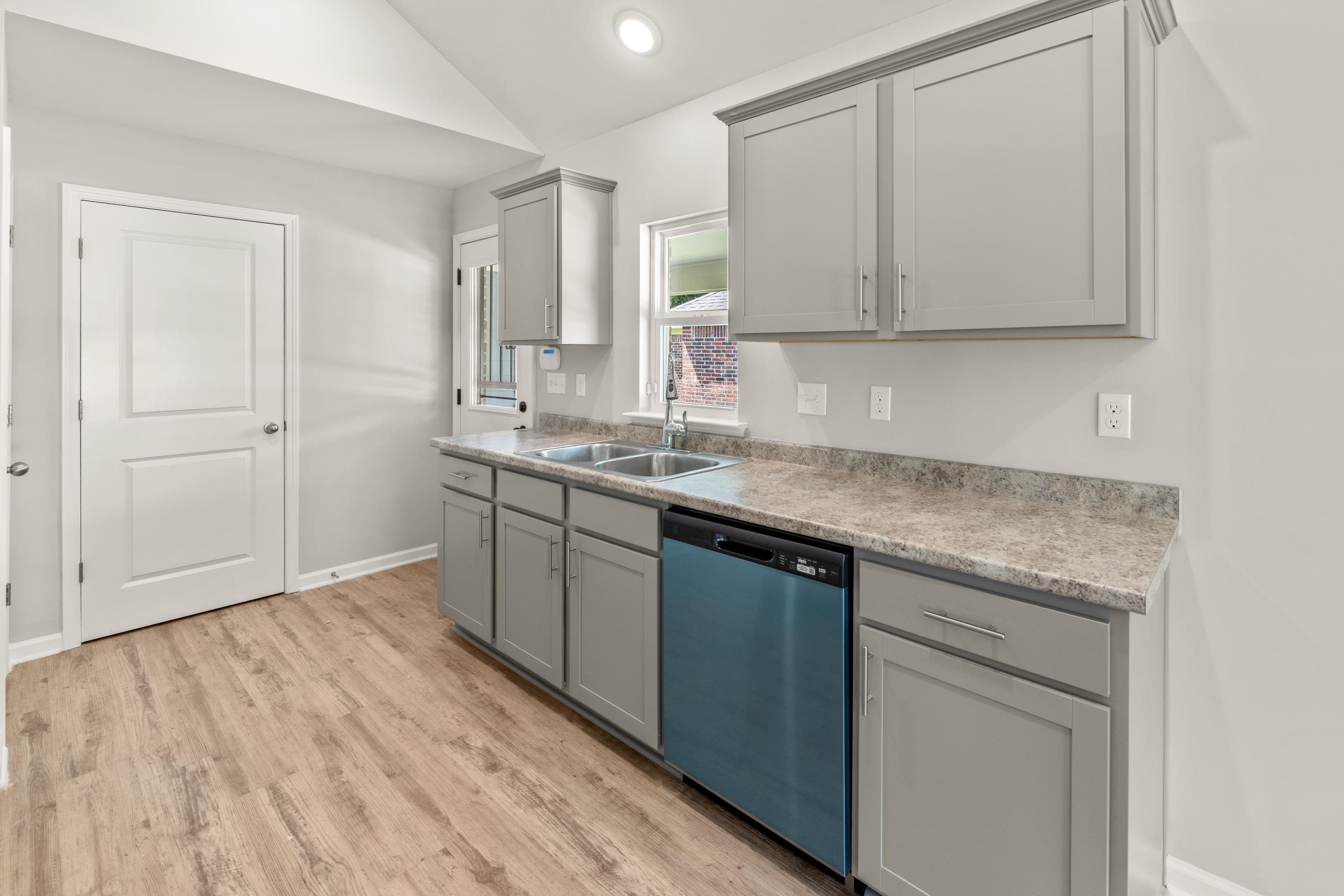 5279 Zodiac Road Memphis, TN 38118 - Photo 11 of 22 a kitchen with a sink dishwasher and cabinets