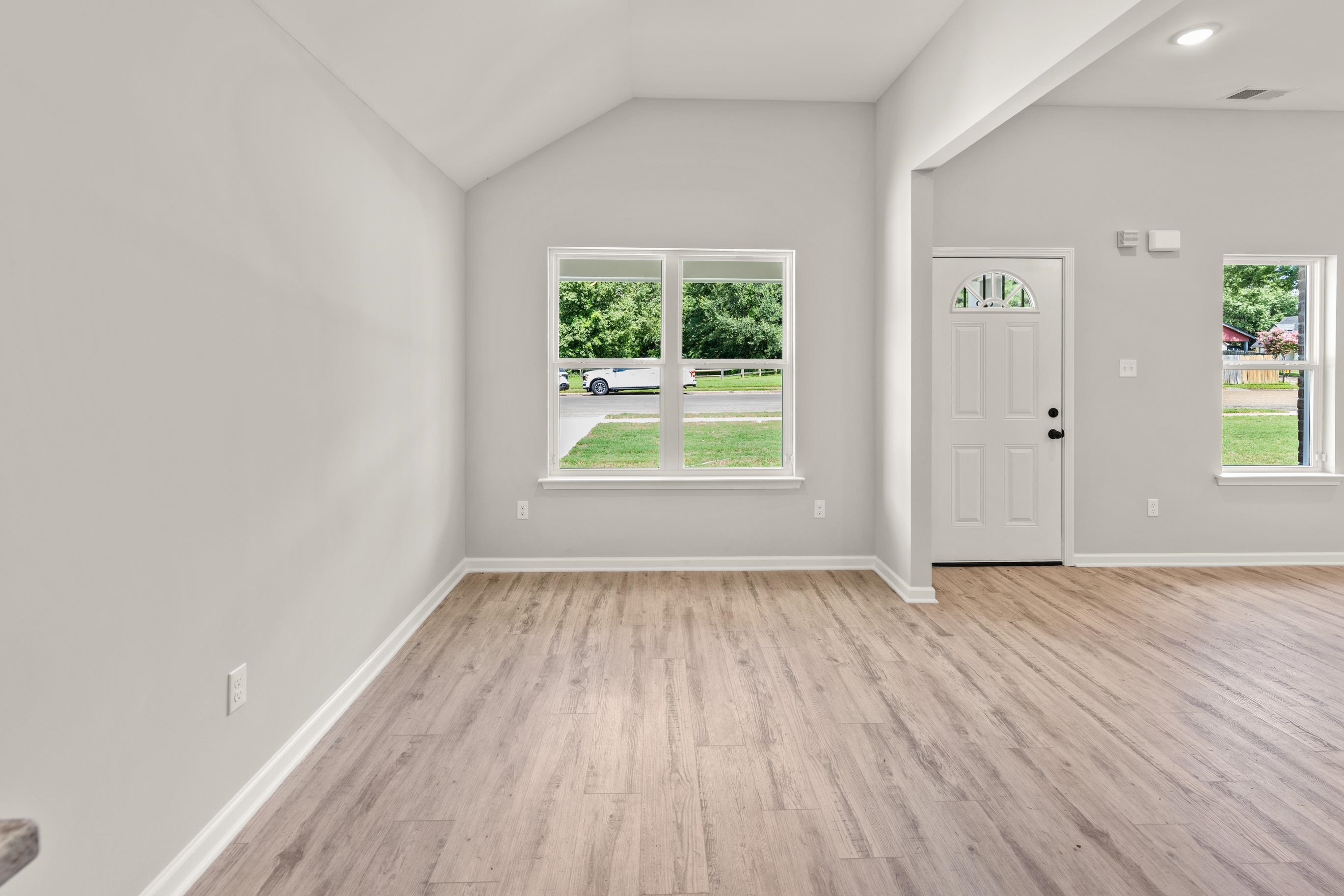 5279 Zodiac Road Memphis, TN 38118 - Photo 12 of 22 a view of an empty room with wooden floor and a window