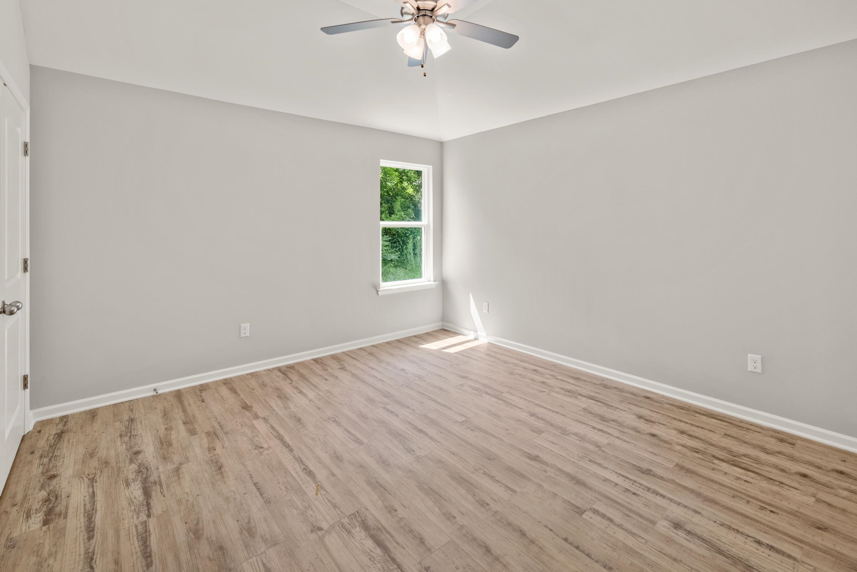 5279 Zodiac Road Memphis, TN 38118 - Photo 16 of 22 wooden floor in an empty room with a window