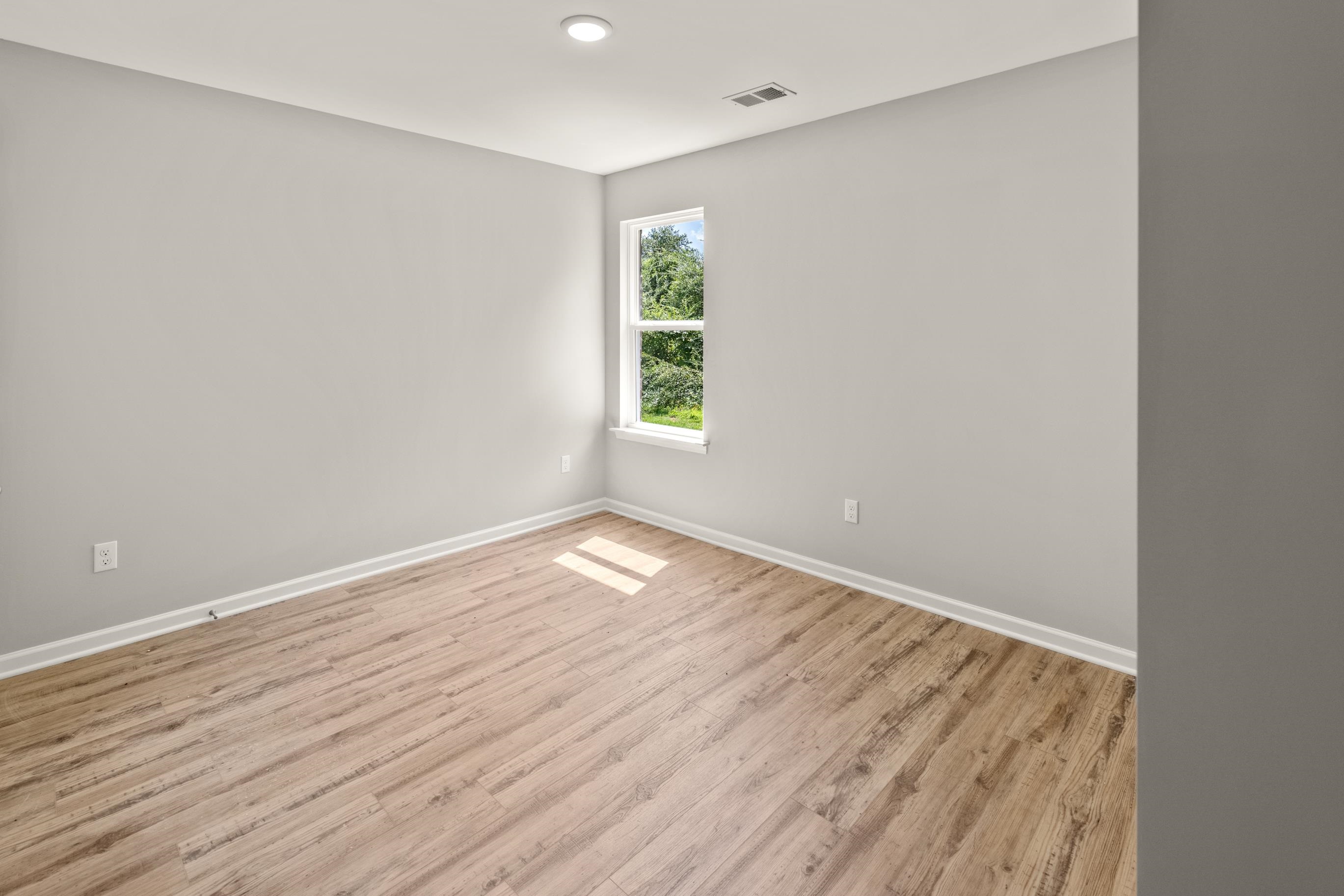 5279 Zodiac Road Memphis, TN 38118 - Photo 19 of 22 an empty room with wooden floor and windows