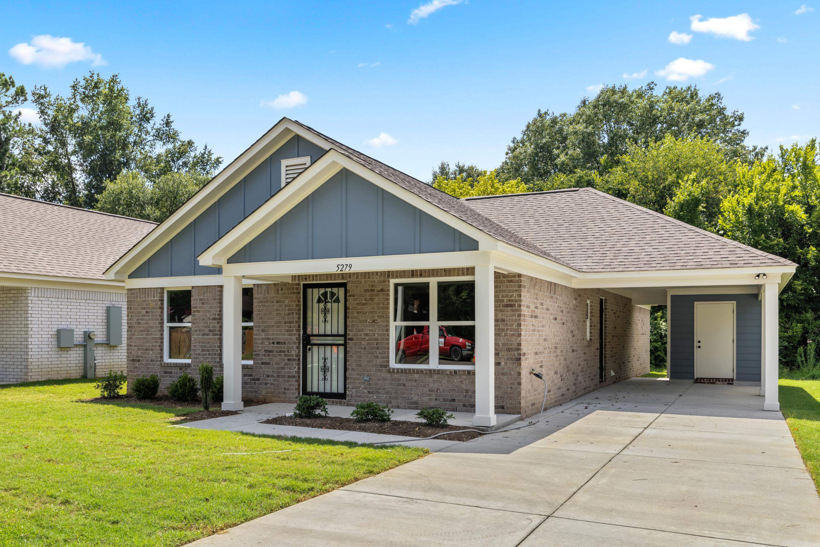 5279 Zodiac Road Memphis, TN 38118 - Photo 2 of 22 a view of house with yard and trees in the background
