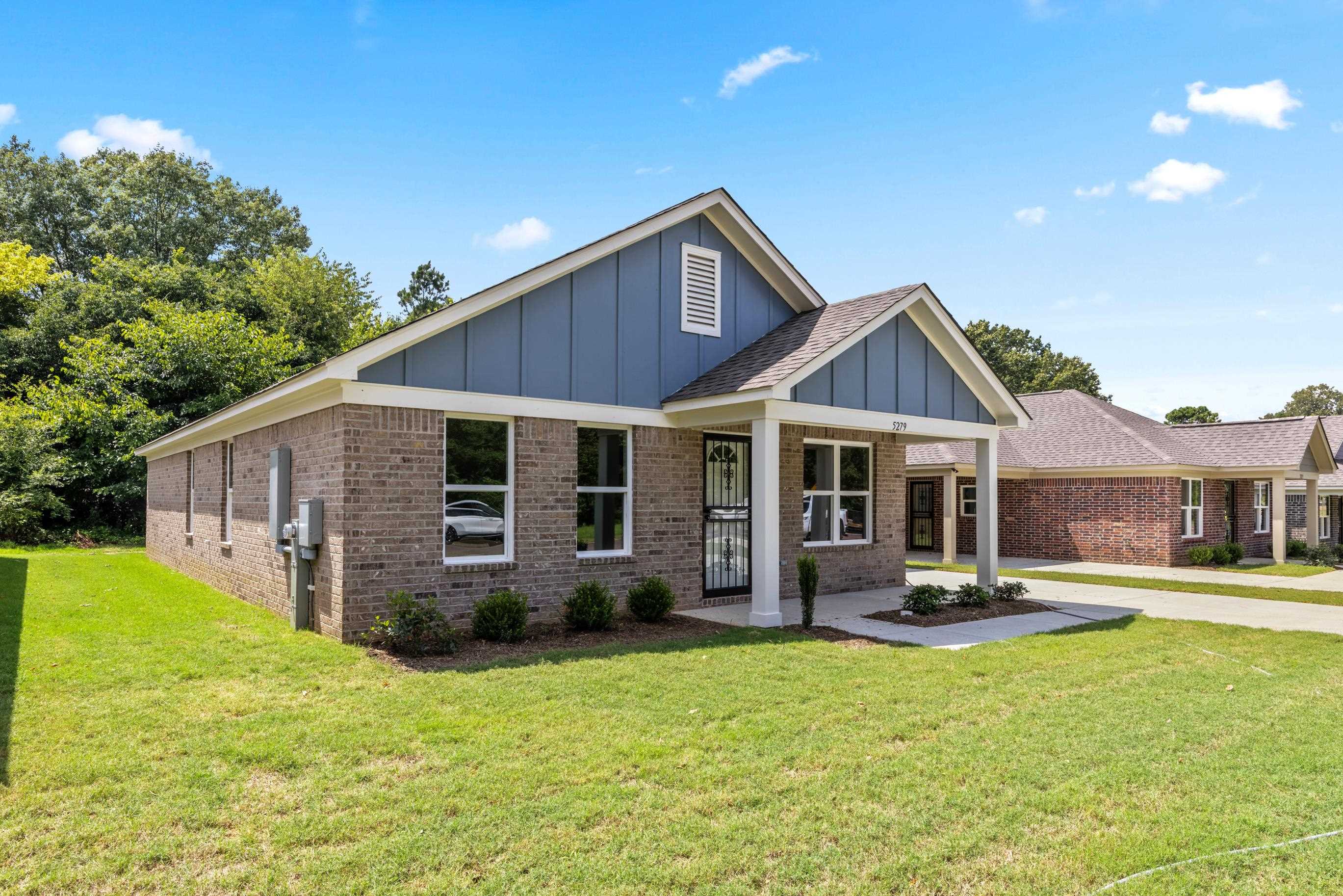5279 Zodiac Road Memphis, TN 38118 - Photo 3 of 22 a front view of a house with a yard