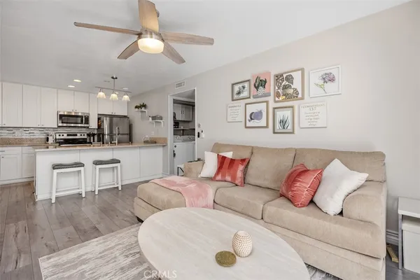 a living room with furniture and kitchen view