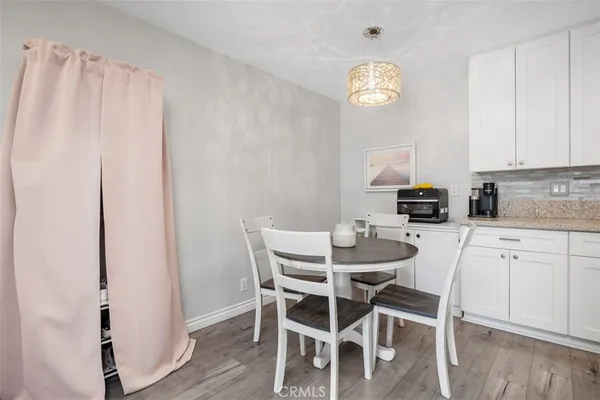 a dining room with furniture and a window