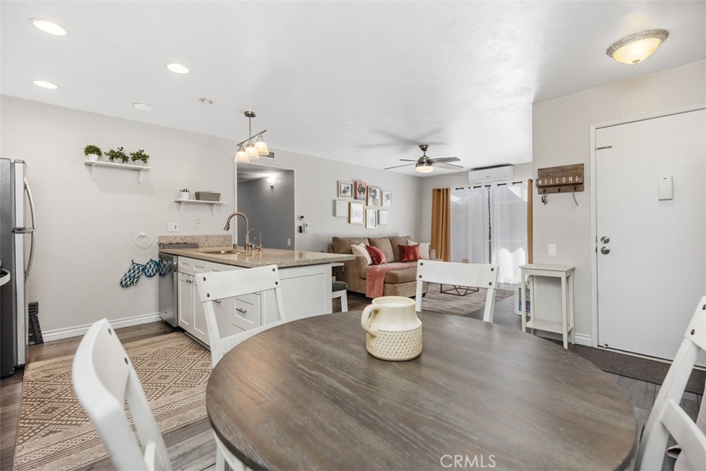 21981 Rimhurst Drive, Unit P160 Lake Forest, CA 92630 - Photo 14 of 35 a large white kitchen with a white countertops a dining table and chairs