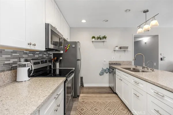 a kitchen with a stove and a sink