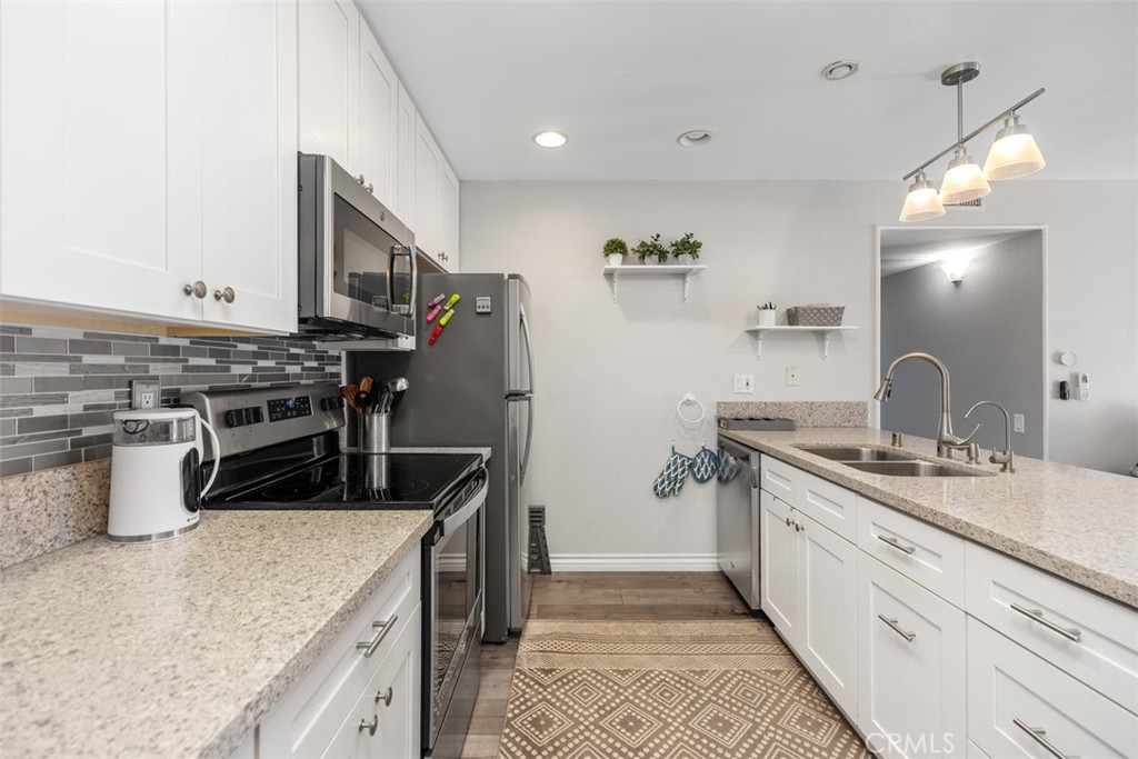 21981 Rimhurst Drive, Unit P160 Lake Forest, CA 92630 - Photo 16 of 35 a kitchen with a stove and a sink