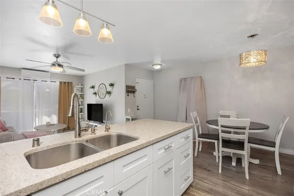 a kitchen with a sink cabinets and chairs
