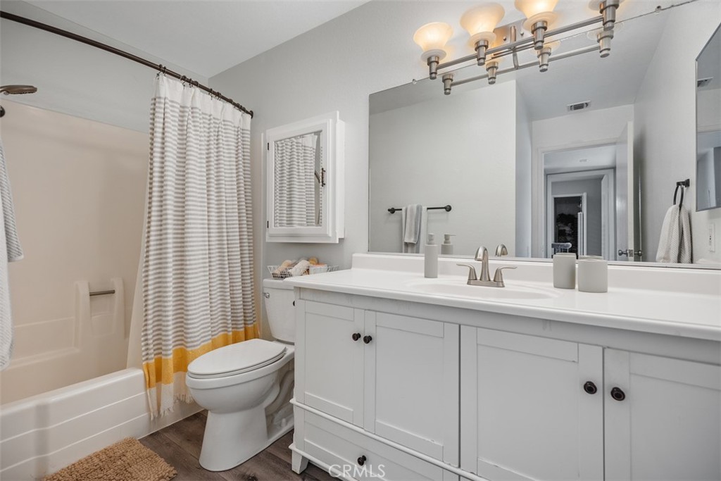 21981 Rimhurst Drive, Unit P160 Lake Forest, CA 92630 - Photo 19 of 35 a bathroom with a toilet sink a mirror a bathtub and shower