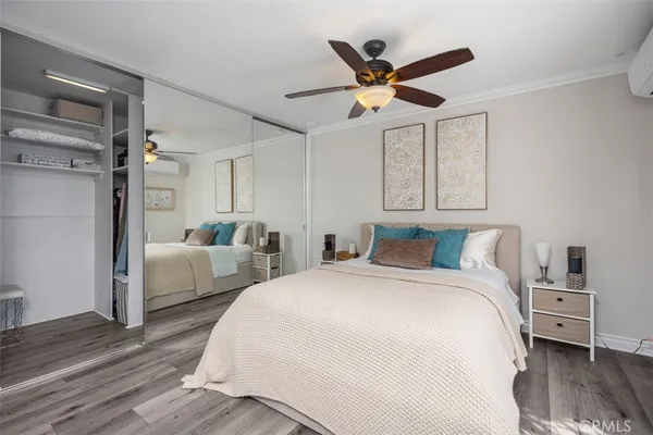 a spacious bedroom with a bed and a ceiling fan