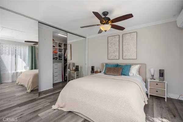 a bedroom with a large bed and a chandelier