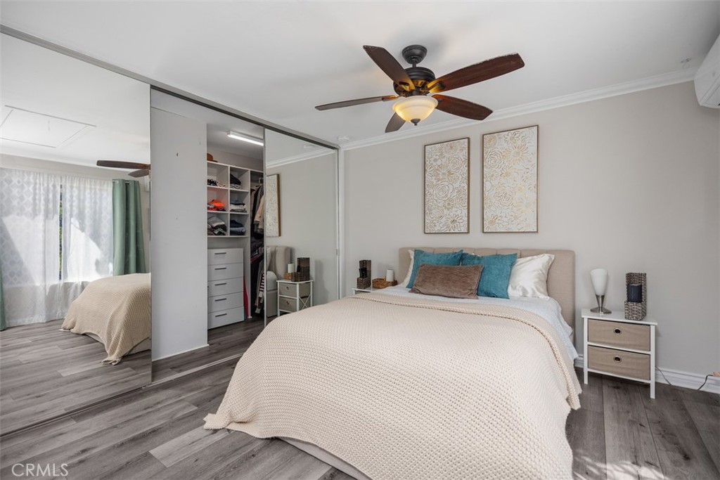 21981 Rimhurst Drive, Unit P160 Lake Forest, CA 92630 - Photo 22 of 35 a bedroom with a large bed and a chandelier