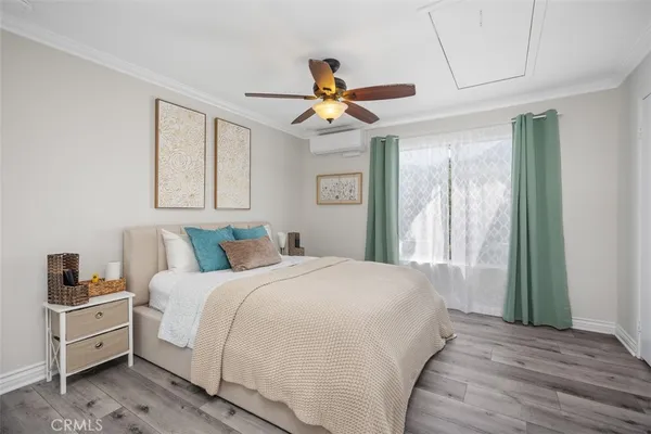 a bedroom with a large bed and a chandelier
