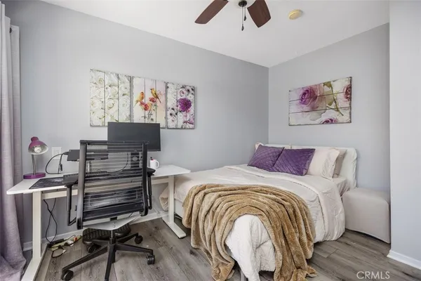 a bedroom with a bed and a desk