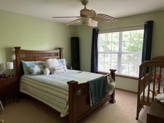 426 Vaughn Circle Aurora, IL 60502 - Photo 13 of 19 a bed sitting in a bedroom next to a window